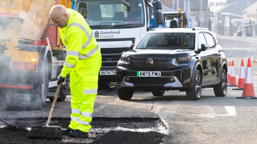 Pothole repair taking place with Citroen in the background