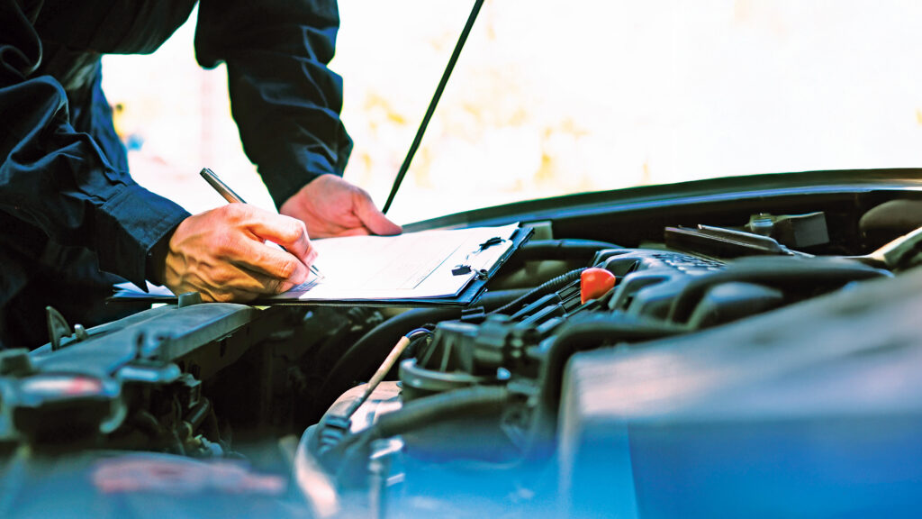 Mechanic inspecting a car's engine bay