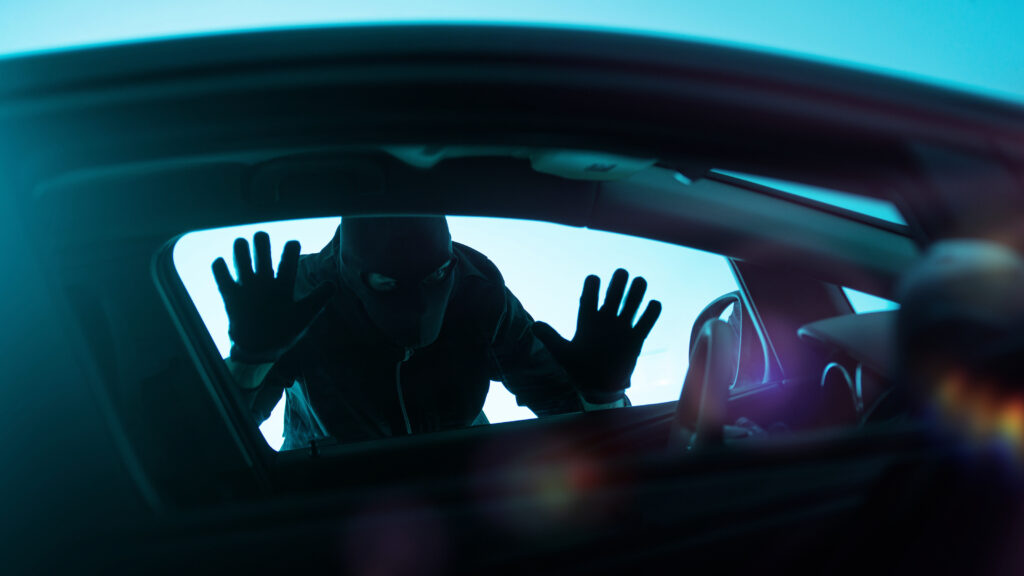 Car thief looking through a window
