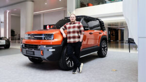 Auto Express news reporter Ellis Hyde standing in front of the Geely Galaxy Cruiser