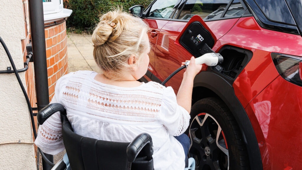 Person in wheelchair plugging in car Alistair Veryard photography
